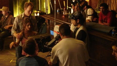 Director Dennis Hauck guides Persephone Apostolou through her dance sequence on the set of AL's BEEF.