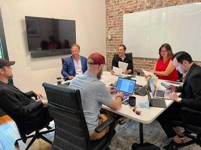 Producers Brian Conley (second from left) and Mark Heidelberger (third from right) hold a production meeting for 