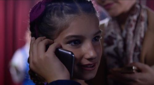 Olivia Valera (Lillian Blankenship) prepares for her talent show performance while speaking with her dad Frank (Antonio 