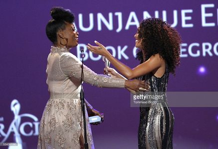 Lex Scott Davis presenting the Gracie Award to Aunjanue Ellis