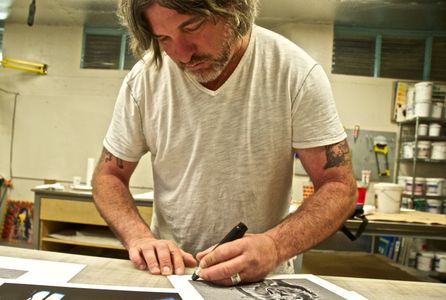 Signing limited edition Lion prints.