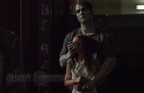 Lily (Lillian Blankenship) held captive by zombie Max (Johnathan Schaech) in 'Day of the Dead: Bloodline (2017)'.