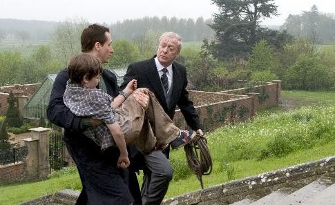 Michael Caine, Linus Roache, and Gus Lewis in Batman Begins (2005)