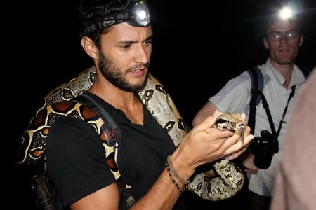 Taking measurements on a red-tailed boa during survey in Yachana, Ecuador.