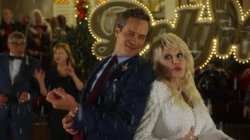 Dolly Parton and Tom Everett Scott in Dolly Parton's Mountain Magic Christmas (2022)