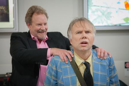 Dunc (actor Robert David Duncan) sneaks up on Mitch (actor Ross Munro) at the airport.