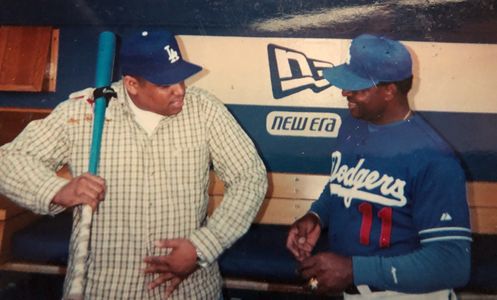 Charles Dirden III and Dodgers batting coach Manny Mota.